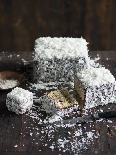 Traditional Australian lamington, coated in chocolate icing and shredded coconut, with a moist sponge interior