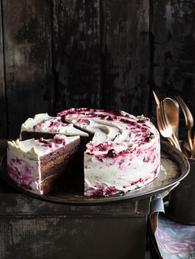 Indulgent blackberry forest cake, layered with moist chocolate sponge, creamy frosting, and tangy blackberry filling, creating a decadent dessert experience